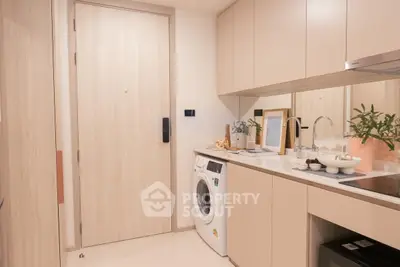 Modern kitchen with washing machine and sleek cabinetry