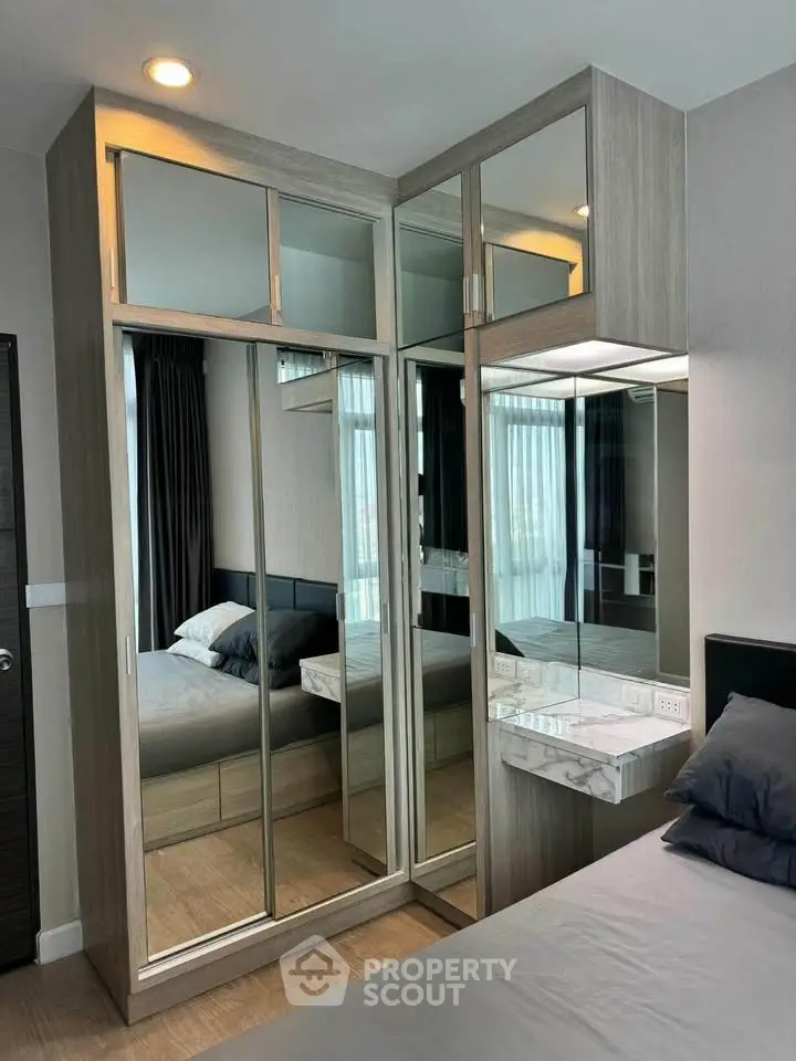 Modern bedroom with mirrored wardrobe and stylish decor