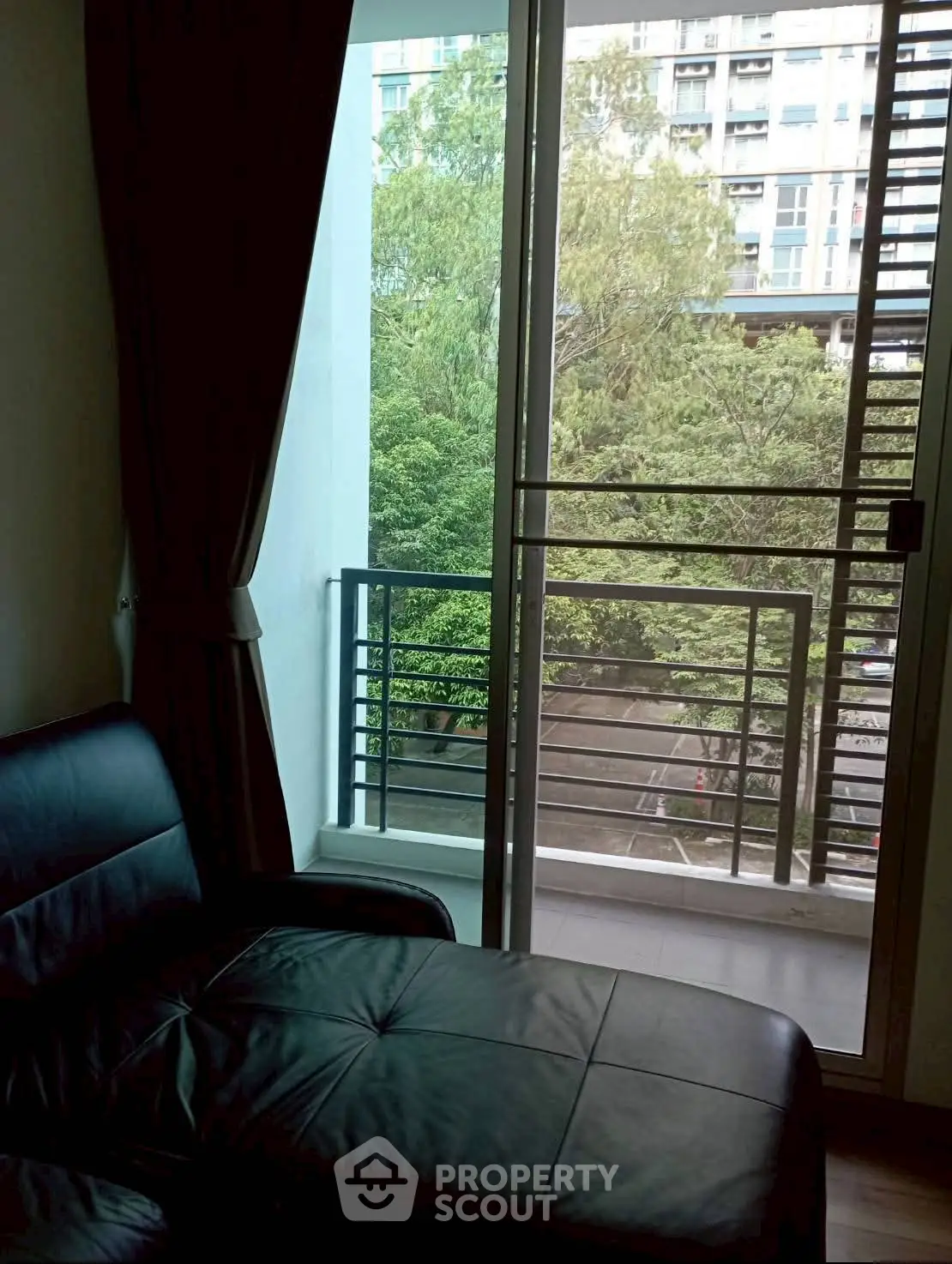 Cozy living room with balcony view in modern apartment