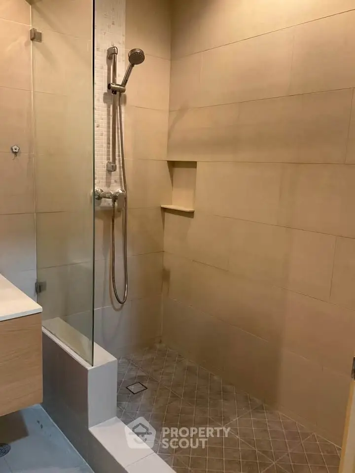 Modern bathroom with sleek shower design and neutral tiles