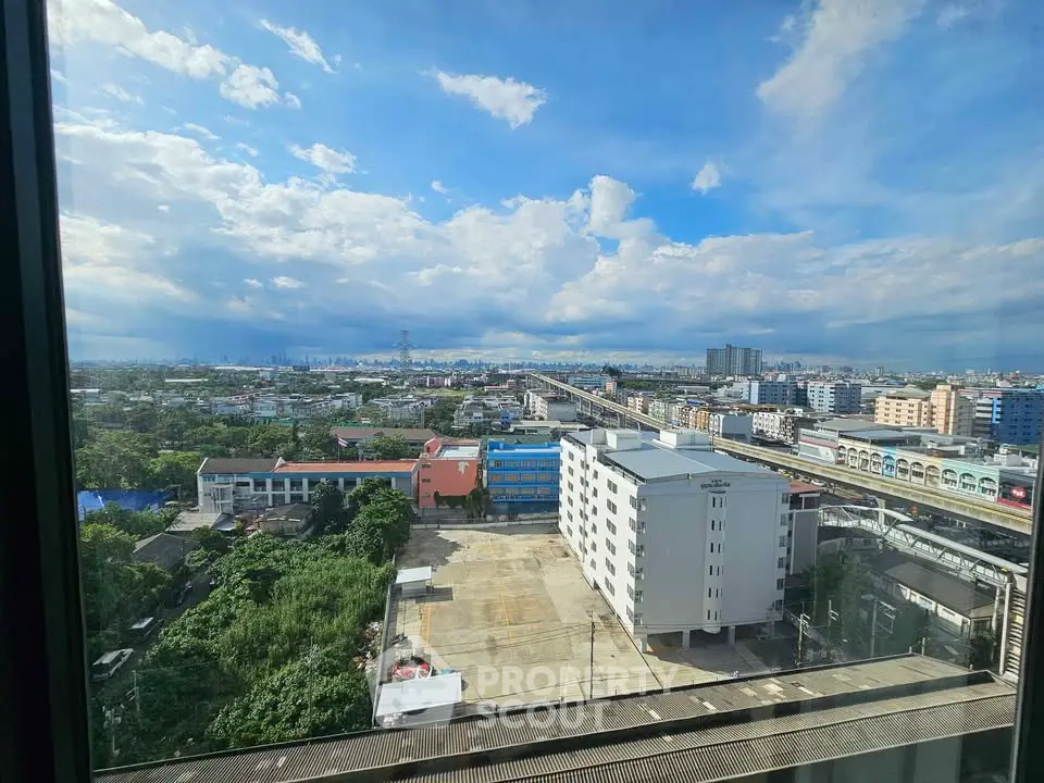 Stunning cityscape view from high-rise window showcasing urban skyline and vibrant neighborhood.