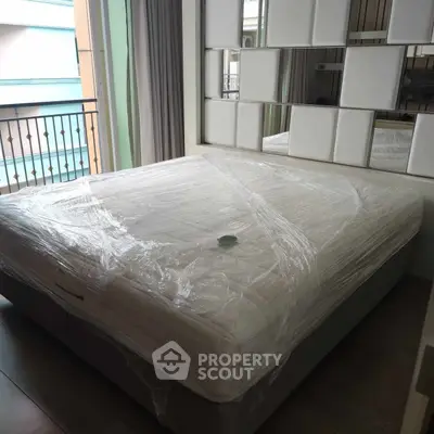 Spacious bedroom with modern decor and large bed near balcony
