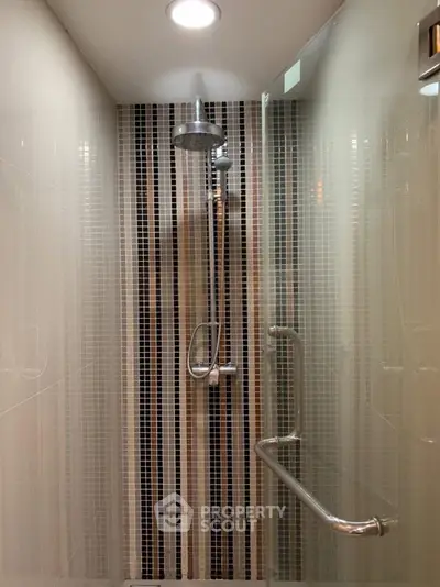 Modern bathroom shower with sleek tile design and chrome fixtures