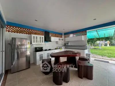 Spacious open kitchen with modern appliances and garden view