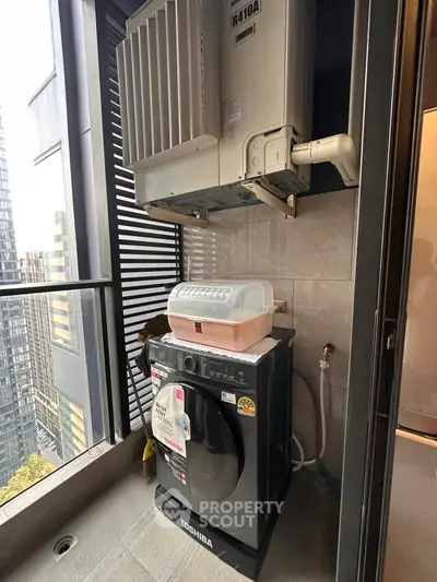 Modern balcony with washing machine and city view, perfect for urban living convenience.