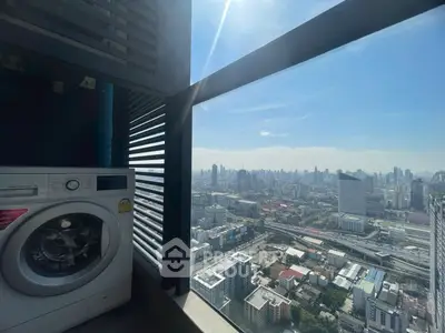 Stunning high-rise city view with in-unit washing machine and modern balcony.