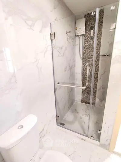 Modern bathroom with sleek shower enclosure and marble tiles