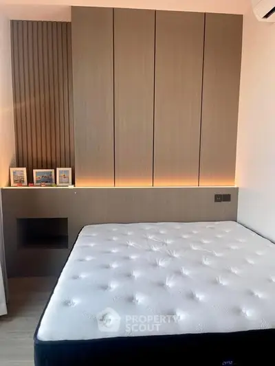 Modern bedroom with stylish paneling and cozy lighting