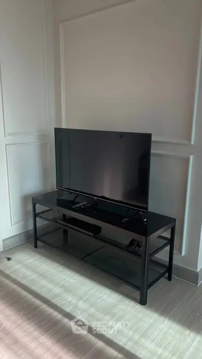 Modern living room with sleek TV stand and flat-screen television