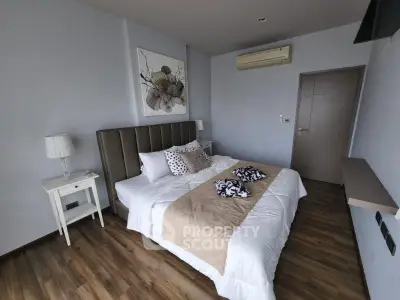 Modern bedroom with stylish decor and wooden flooring