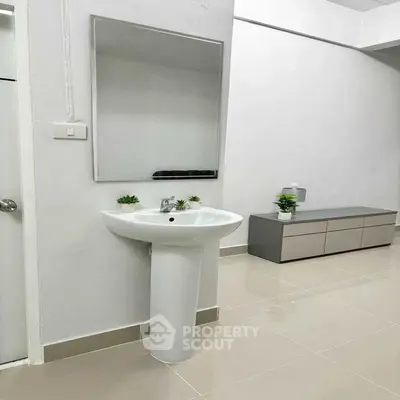 Modern bathroom with sleek pedestal sink and minimalist decor