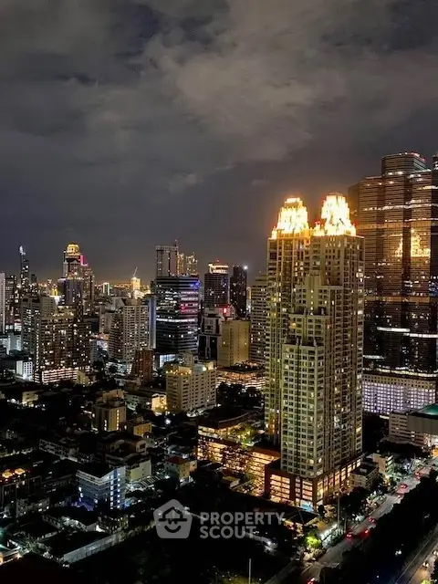 Stunning cityscape view with illuminated skyscrapers at night, showcasing urban living.