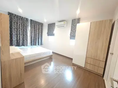 Spacious bedroom with modern furnishings and natural light