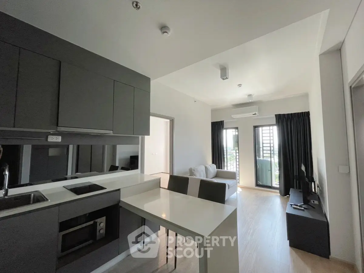 Modern open-layout kitchen and living room with sleek design and natural light