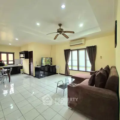 Spacious living room with modern furniture and open kitchen layout