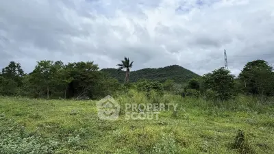 Scenic land plot with lush greenery and mountain views, perfect for development or investment.