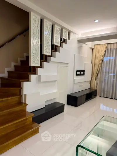 Modern living room with elegant staircase and stylish decor