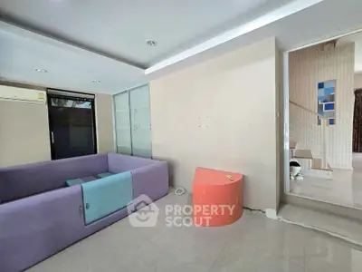 Modern living room with unique purple sofa and minimalist design