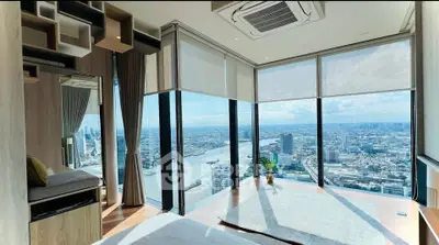 Luxurious corner unit with panoramic city and river views, featuring floor-to-ceiling windows and modern decor.