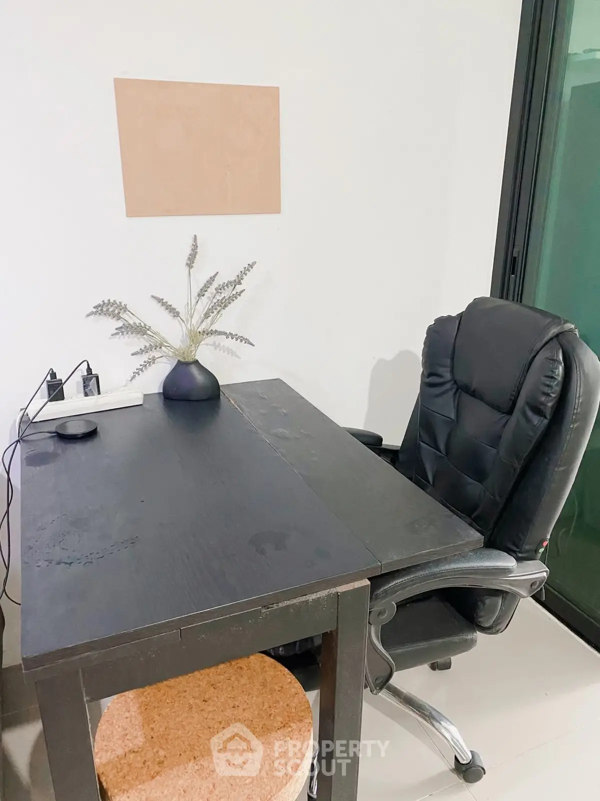 Modern study area with sleek black desk and ergonomic chair, perfect for productivity.