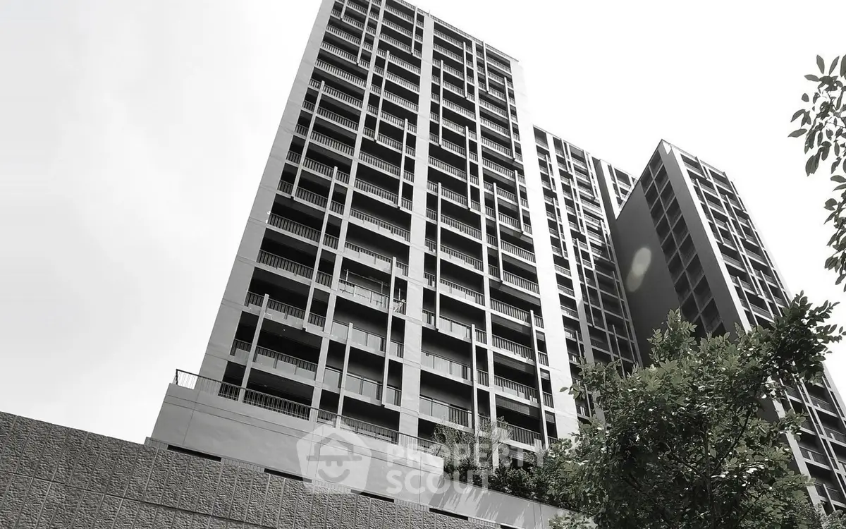 Modern high-rise building with sleek design and spacious balconies.