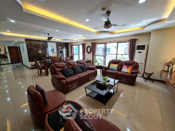 Spacious and elegant living room with luxurious leather seating and modern decor.