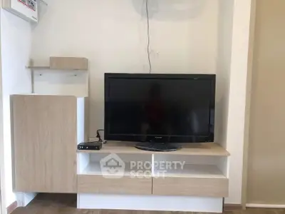 Modern living room with sleek TV stand and mounted television, perfect for entertainment.