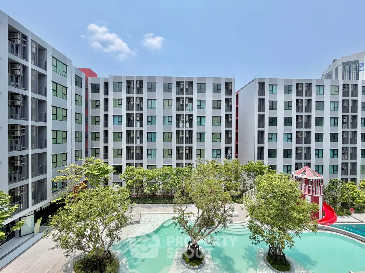 Modern apartment complex with pool and lush greenery, perfect for urban living.
