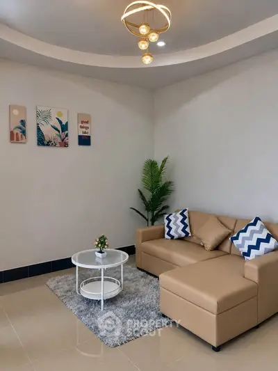 Modern living room with stylish decor, cozy sofa, and elegant lighting in a contemporary apartment.