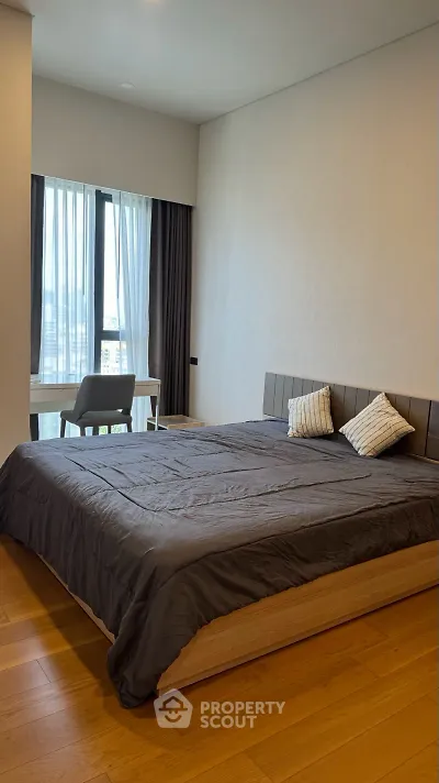 Modern bedroom with large window and stylish decor