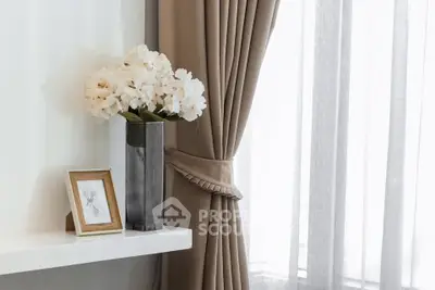 Elegant interior with stylish curtains and floral decor on a sleek shelf, perfect for modern living spaces.