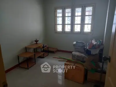 Cozy small room with tiled floor and window, ideal for storage or study.