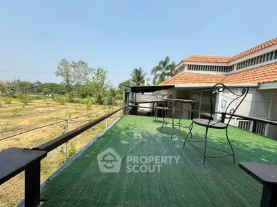 Spacious outdoor balcony with scenic garden view in a modern home