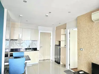 Modern kitchen and dining area with sleek design and light wood cabinetry