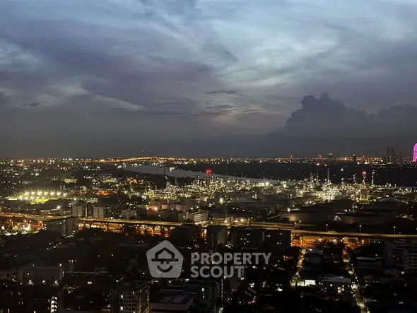 Stunning cityscape view at dusk with twinkling lights and expansive skyline.