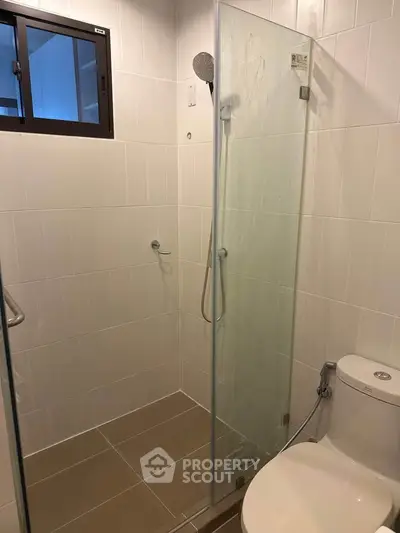 Modern bathroom with glass shower and sleek tile design