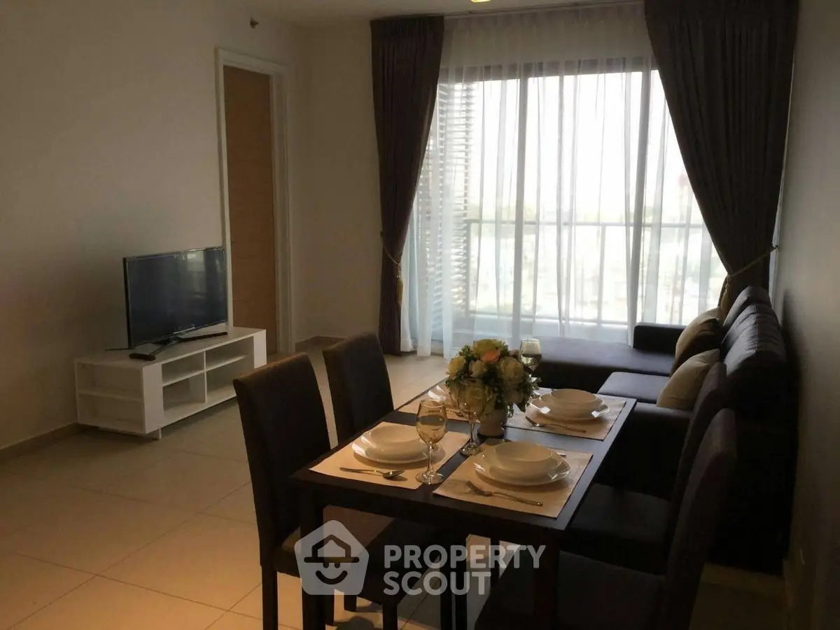 Modern living room with dining area and large window, perfect for cozy gatherings.