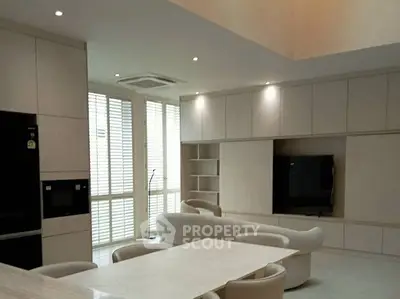 Luxurious modern living room with sleek furniture and built-in entertainment center.