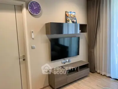 Modern living room with wall-mounted TV and stylish wooden shelves