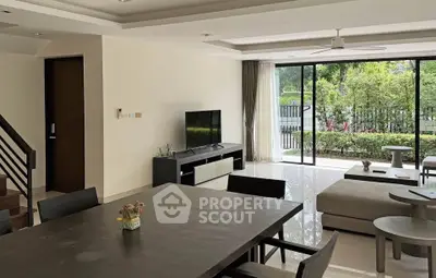 Spacious modern living room with garden view and elegant dining area