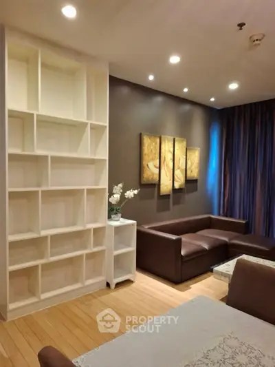 Modern living room with stylish brown sofa and elegant wall art