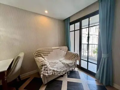 Cozy living room with stylish sofa and large window leading to a balcony, perfect for relaxation.