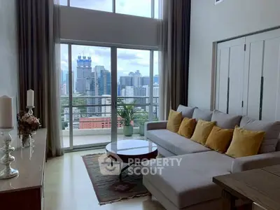 Spacious living room with city view and large balcony access, featuring modern decor and comfortable seating.