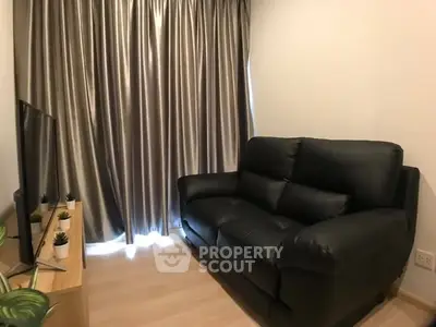 Cozy living room with black leather sofa and modern decor