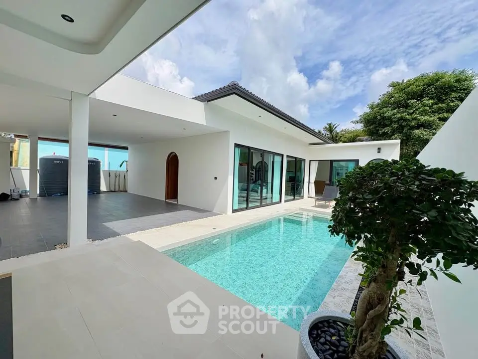 Luxurious modern villa with private pool and sleek architecture under a clear blue sky.