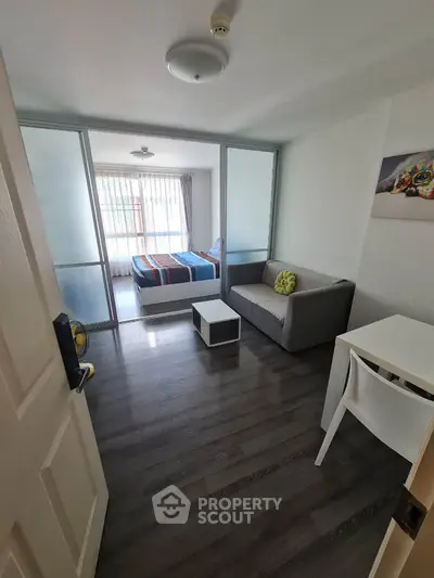 Modern studio apartment with sleek flooring and cozy furnishings