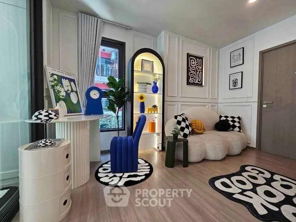 Stylish modern living room with unique furniture and decor, featuring a cozy seating area and vibrant accents.