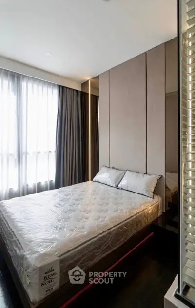 Modern bedroom with large window and elegant decor