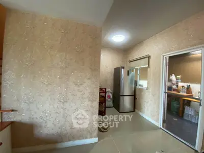 Spacious kitchen with modern fridge and elegant wallpaper design