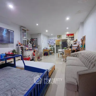 Spacious living room with modern decor and ample seating in a cozy home setting.